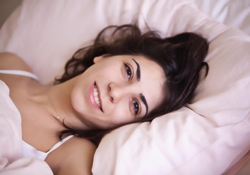 Mujer descansando en la cama , con insomnio y  cambios hormonales